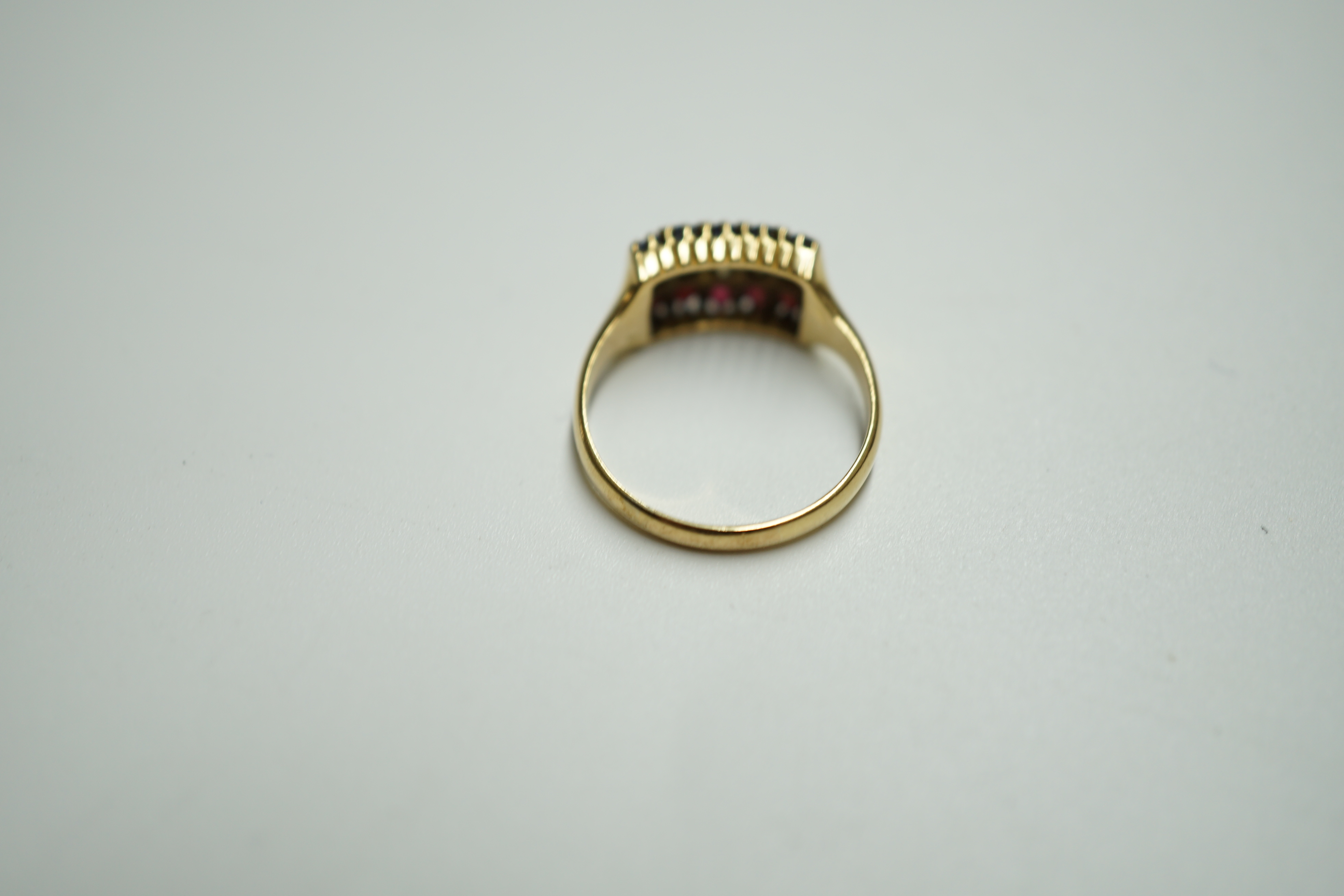 An early 20th century gold and three row sapphire, ruby and diamond set ring, size M, gross weight 3.1 rams. Condition - poor to fair
